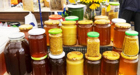 Natural sweet healthy honey in glass jars for sale on display . Healthy eating. Healthy lifestyle.