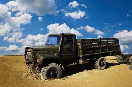 Photo for A damaged military truck on the battlefield. military technics - Royalty Free Image