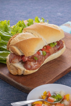 Choripan, typical argentine sandwich with chorizo and creole sauce.