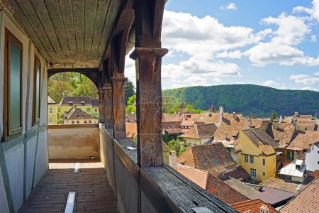 Photo for Landscape from the top level of the Clock Tower in the Romanian city of Sighisoara: a fragment of the old wooden gallery and a breathtaking view of the buildings in the Old Town - Royalty Free Image