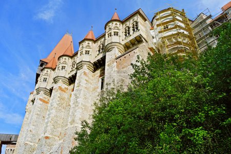 Photo for Bottom-up view of the medieval gothic Corvin Castle located in the city of Hunedoara in Romania - Royalty Free Image