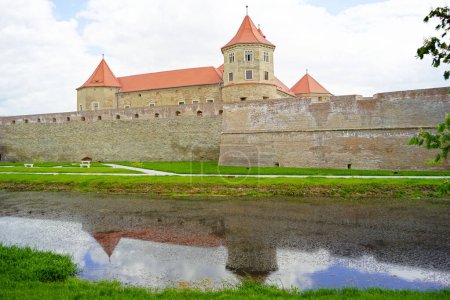 Architecture of the Romanian fortress Fagaras: view of the defensive walls and the palace with the towers behind them from the opposite side of the moat