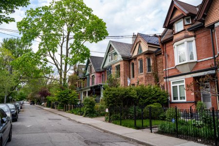 Street with narrow Victorian semi detached houses in Toronto.
