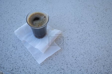 Photo for Coffee cup with napkin on white marble table background. - Royalty Free Image