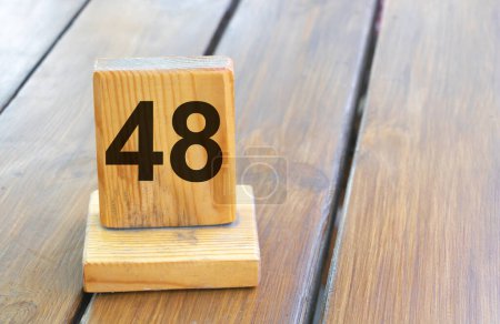 Wooden priority number 48 on a plank tab.