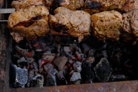 Cooking meat on a charcoal grill. Fried fatty food on a fire. Delicious calorie non vegetarian food. street food kebab