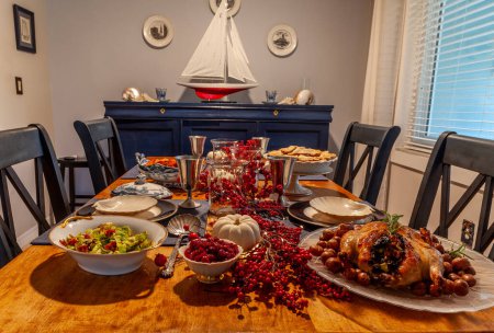 Roasted duck, stuffing, brussels sprouts, and yams on a holiday table with fine China.