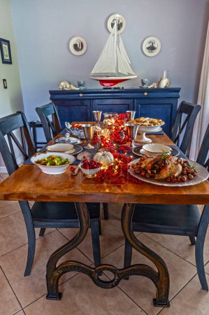Roasted duck, stuffing, brussels sprouts, and yams on a holiday table with fine China.