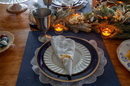 Christmas place setting and greenery on a table with fine bone China.