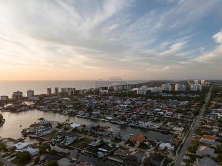 Sunset aerial sky view of Vanderbilt Beach and the ocean in Naples, Florida