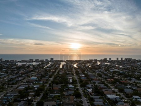 Sunset aerial sky view of Vanderbilt Beach and the ocean in Naples, Florida