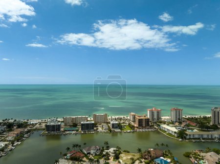 Aerial sky view of Vanderbilt Beach and the ocean on a sunny day in Naples, Florida