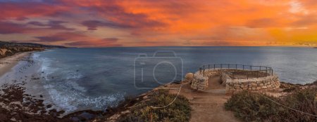 Sunset in a stone overlook that views Crystal Cove State Park Beach in Fall near Newport Beach, California