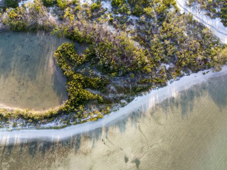 Overhead view of Bonita Beach and a lagoon before the ocean in an aerial view.