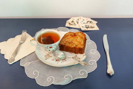 Afternoon tea and carrot cake on a snack dish during a card game.