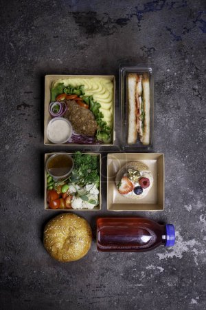 Variety of lunch boxes with healthy and tasty food. Isolated on table. Concept of healthy eating, dieting, food delivery or catering.