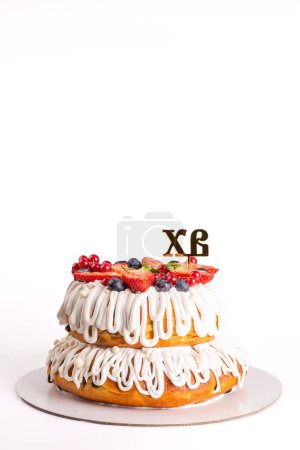 A two-tiered White Round festive Easter cake on a white background. Orthodox holiday.