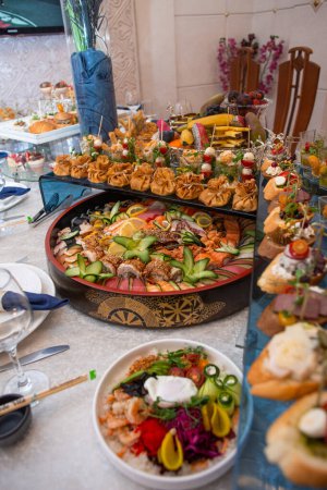 An opulent buffet showcasing a lavish assortment of fresh seafood, sushi, salads, fruits, and pastries, beautifully arranged on a pristine white tablecloth for a luxurious and celebratory event.