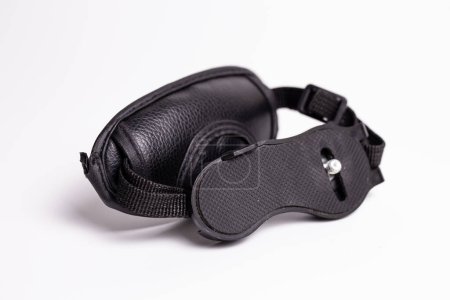 Black leather camera hand strap with metal carabiner. Comfortable, stylish accessory for photographers. Ensures secure grip for your camera, enhancing photography experience.