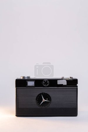 Photo for Vintage film camera with a sleek silver body and a classic black manual focus lens, elegantly displayed against a clean white background. - Royalty Free Image
