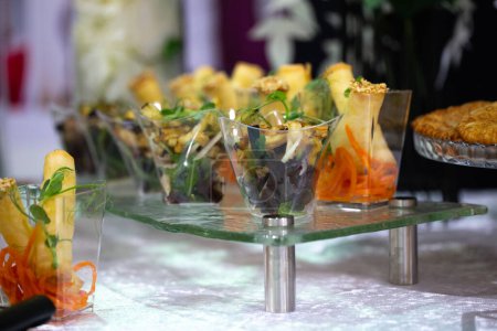 Delicious appetizers on a glass tray for catering event. Mini tacos, bruschetta, savory treats. Perfect for parties, weddings, and more.