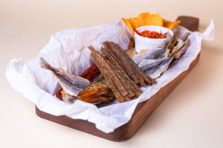 assorted dry fish for beer. fish on a wooden board.