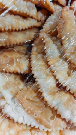 A variety of freshly baked homemade traditional pastries wrapped in plastic and ready to be enjoyed as a delicious snack or dessert.