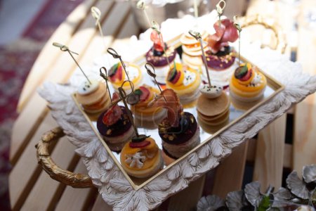 Delectable mini pancakes on mirrored tray, perfect for catering events. Bite-sized treats to tantalize taste buds elevate events.