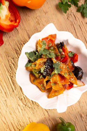 A delicious and nutritious plate of stir-fried pumpkin with black fungus and red peppers, a perfect combination of flavors and textures.