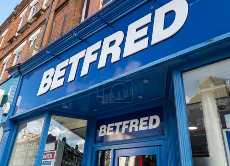 Photo for London. UK- 04.12.2023. The company name sign above the entrance of a retail branch of Betfred book maker, betting shop. - Royalty Free Image