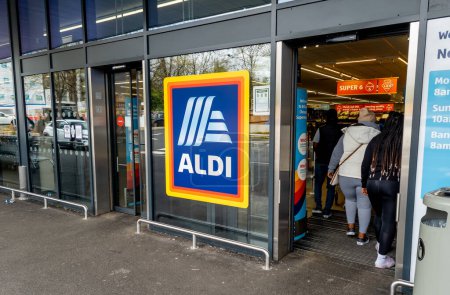 Photo for London. UK- 05.01.2023. The entrance and exit of a branch of Aldi grocery supermarket with the company name sign and logo in the middle. - Royalty Free Image