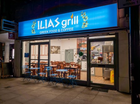 Photo for London. UK- 01.19.2024. A night time shot of a  recently opened restaurant selling Greek grill food and coffee. - Royalty Free Image