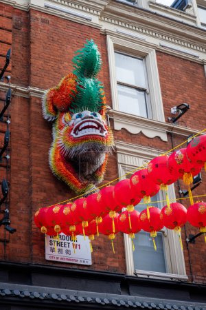 London. UK- 02.11.2024. The figure of a mythical lion hanging on the wall of a building in China Town as part of the Lunar New Year celebration.