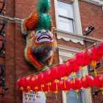 London. UK- 02.11.2024. The figure of a mythical lion hanging on the wall of a building in China Town as part of the Lunar New Year celebration.