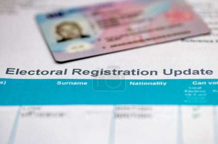 An Electoral Registration Update document with a driving licence, with changes where voters need to provide identification before voting.