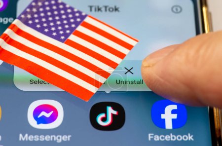 Photo for London. UK- 04.26.2024. A US TikTok ban concept with the Chinese app on the screen of an Android phone, the US flag and a finger going to press the uninstall option. - Royalty Free Image