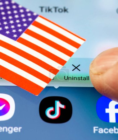 Photo for London. UK- 04.26.2024. A US TikTok ban concept with the Chinese app on the screen of an Android phone, the US flag and a finger going to press the uninstall option. - Royalty Free Image