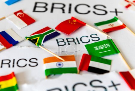 A BRICS and BRICS+ concept with the words and country flags of the block of countries and new members.