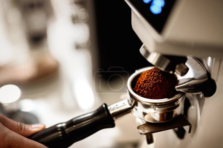Photo for Preparing fresh coffee. Closeup of tamping Fresh Ground Coffee. - Royalty Free Image