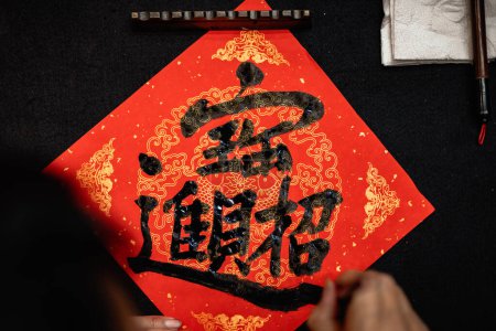 Foto de Writing Chinese calligraphy with word meaning "Good Fortune" for Taditional Chinese new year - Imagen libre de derechos