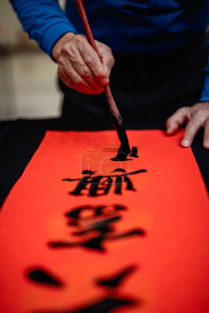 Photo for Writing Chinese calligraphy with word meaning "Good Fortune" for Taditional Chinese new year - Royalty Free Image