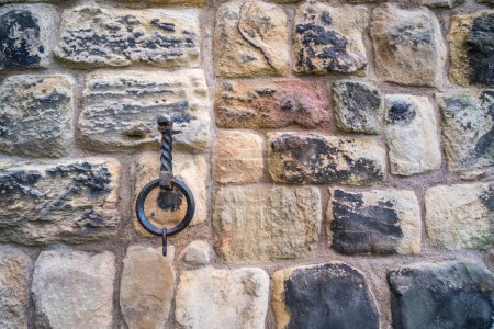 Old brick stone wall background with iron loop