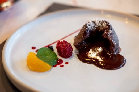 Chocolate lava on plate, with fruit and sauce