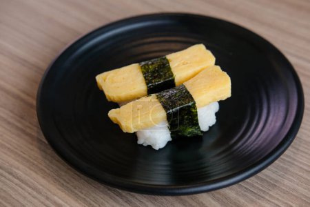 Photo for Tamago egg sushi, egg omelet on sushi rice. served on plate - Royalty Free Image
