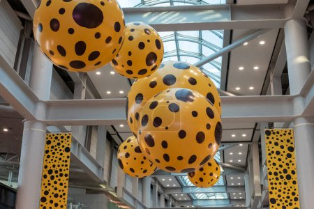 Photo for Seoul, South Korea - 20 February 2023: Lady B, sculpture installation by artist Yayoi Kusama collaborated with Louis Vuitton at Incheon Airport. Yellow ball with black dots pattern. - Royalty Free Image