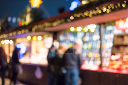 Photo for Blurred image bokeh of People walking, shopping at Winter Wonderland, a Christmas Market in Hyde Park, London. - Royalty Free Image