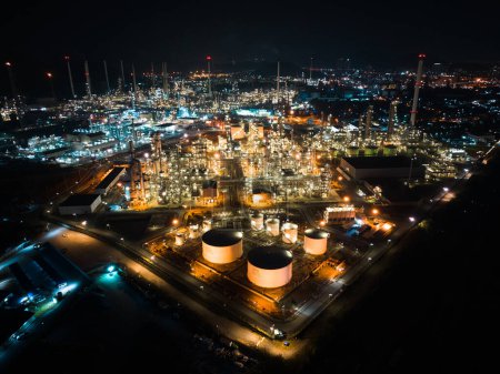 Photo for Petroleum oil refinery in industrial estate at night, drone aerial view. Fuel and power generation, petrochemical factory industry, or environmental air pollution concept - Royalty Free Image