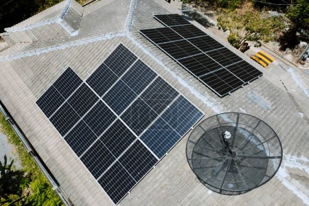 Photo for Solar grid panels on domestic house rooftop in Asia on sunny summer day. Drone aerial view. Natural perpetual power technology, clean sustainable energy, zero waste lifestyle concept. - Royalty Free Image