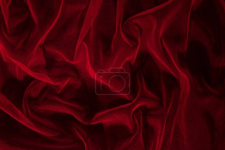 Dunkel-elegante Tapete aus rotem Tüll. Ästhetische Mode, Leidenschaft und Liebe Hintergrund.
