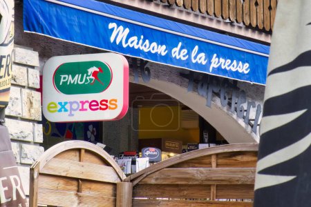 Photo for Thones, france - 03 September 2022:the sign of PMU, the french gambling company is hanging above an historic village newspaper store - Royalty Free Image